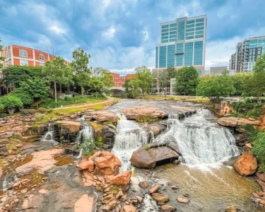 Waterfall At Falls Park On The Reedy Surrounded By Buildings