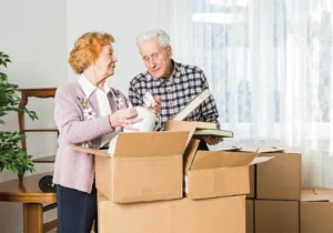 elderly couple packing boxes